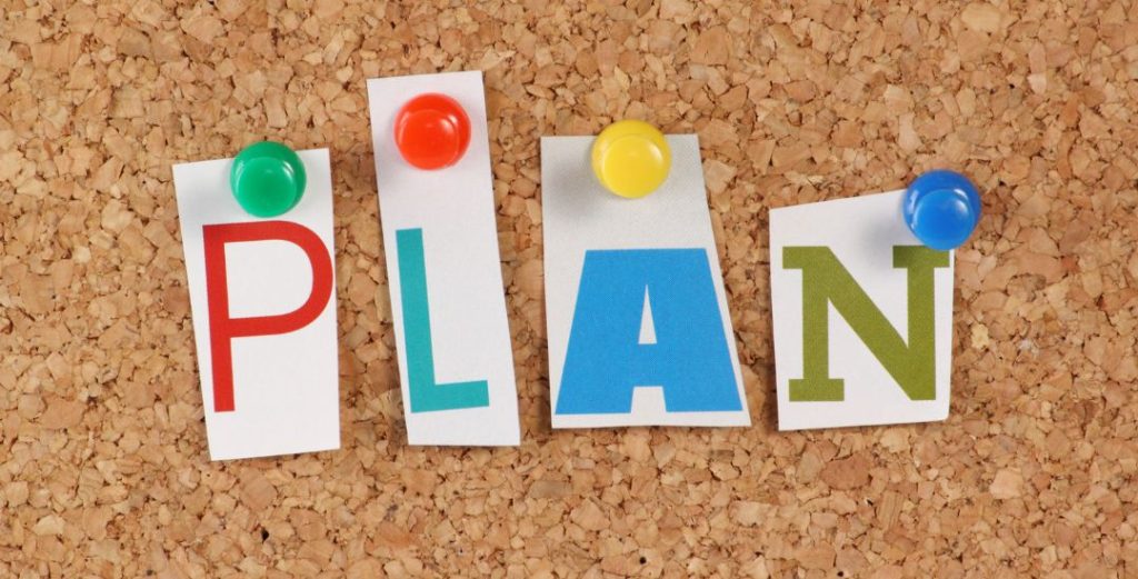 plan letters pinned to cork board