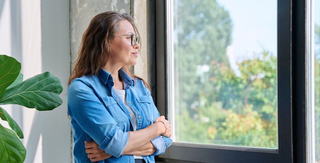 woman looking out window